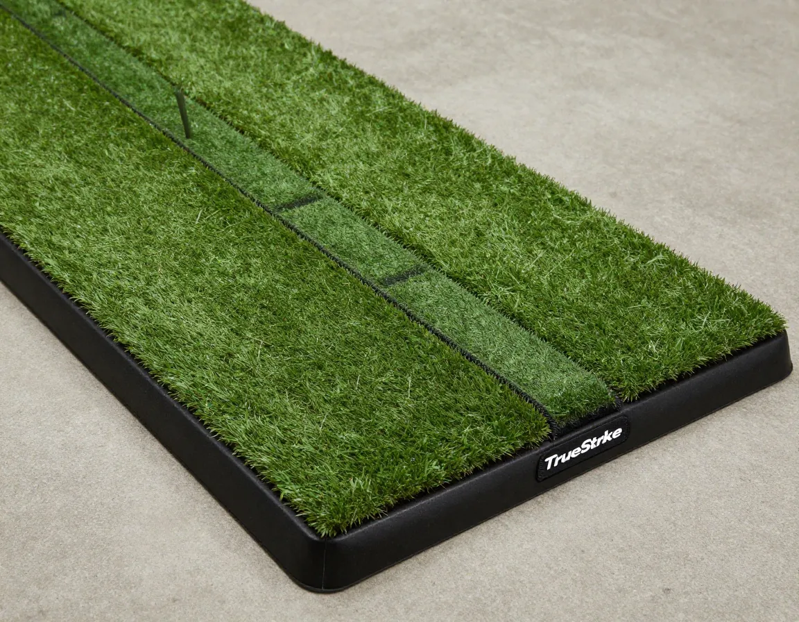 Professional grade hitting mat with replaceable turf strip on concrete floor