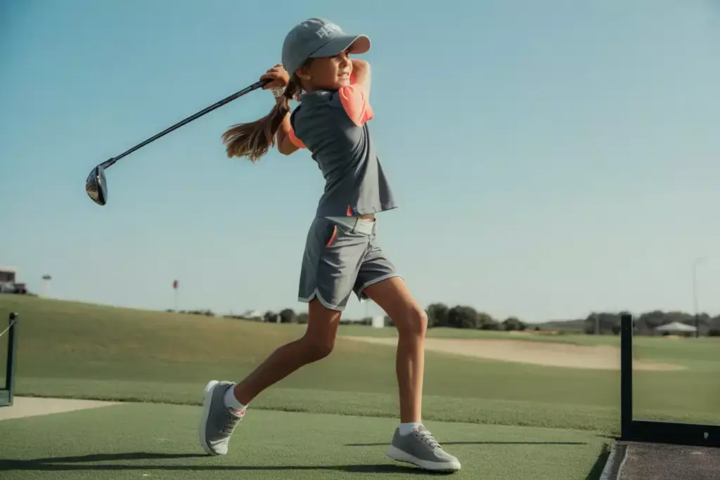 Sporty Athleisure Golfer Mid Swing In Performance Polo And Shorts On Driving Range