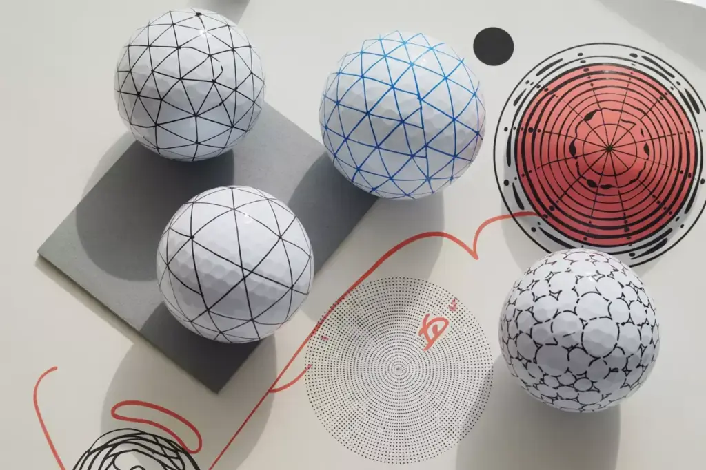 Modern geometric patterns artistic golf ball designs flatlay