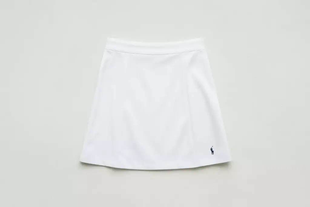 Crisp white a line golf skirt flat lay with logo embroidery