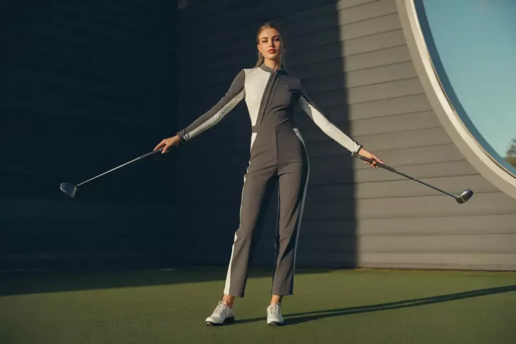 Fashion model in tailored golf jumpsuit color block design