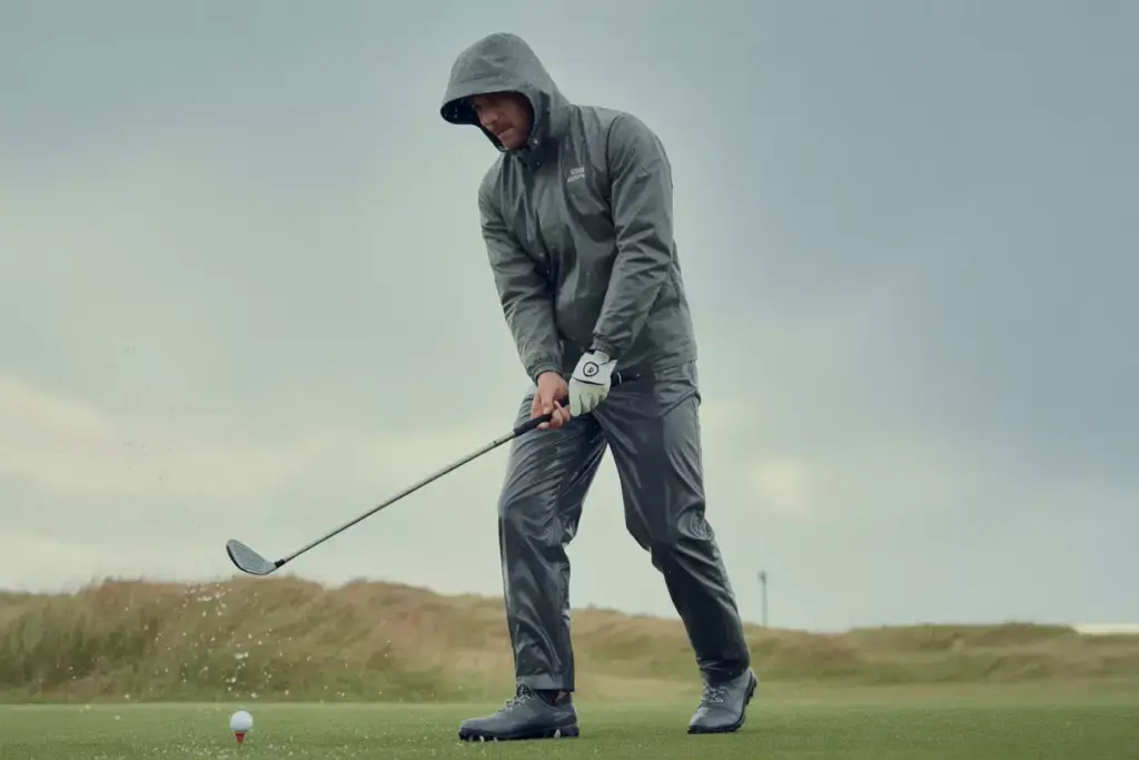 Golfer In Waterproof Gear Braving Rain On A Course During Tournament Play