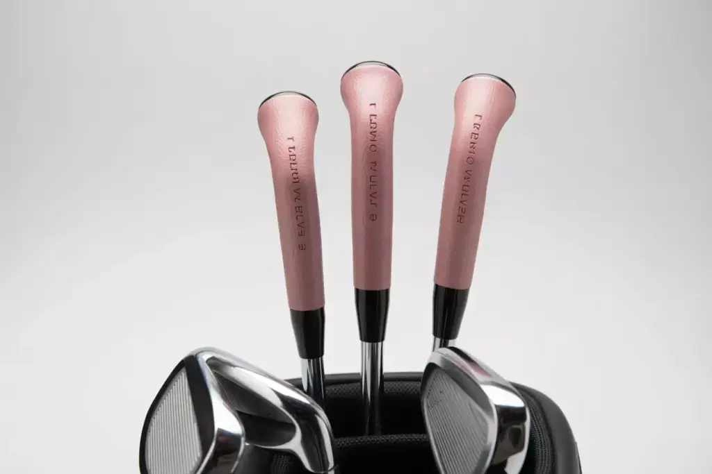 Set of irons with pink tour velvet grips in golf bag