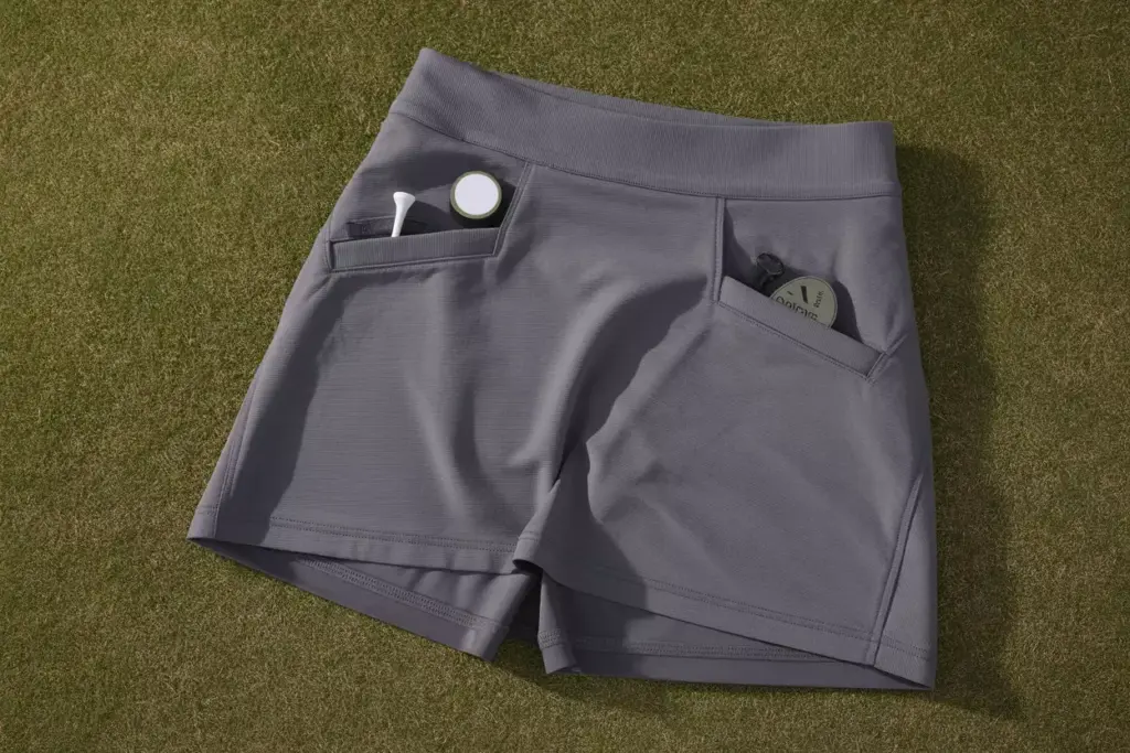 Performance primegreen skort on golf course with accessories