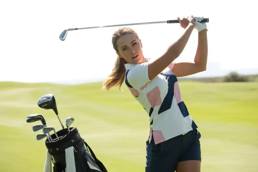 Modern Womens Golf Polo Shirt Demonstrating Stretch And Performance During A Full Swing On A Sunny Fairway