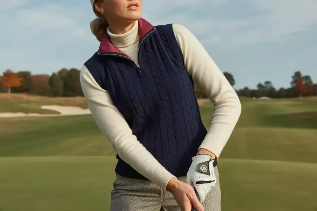 Classic layered professional golf outfit on autumn fairway
