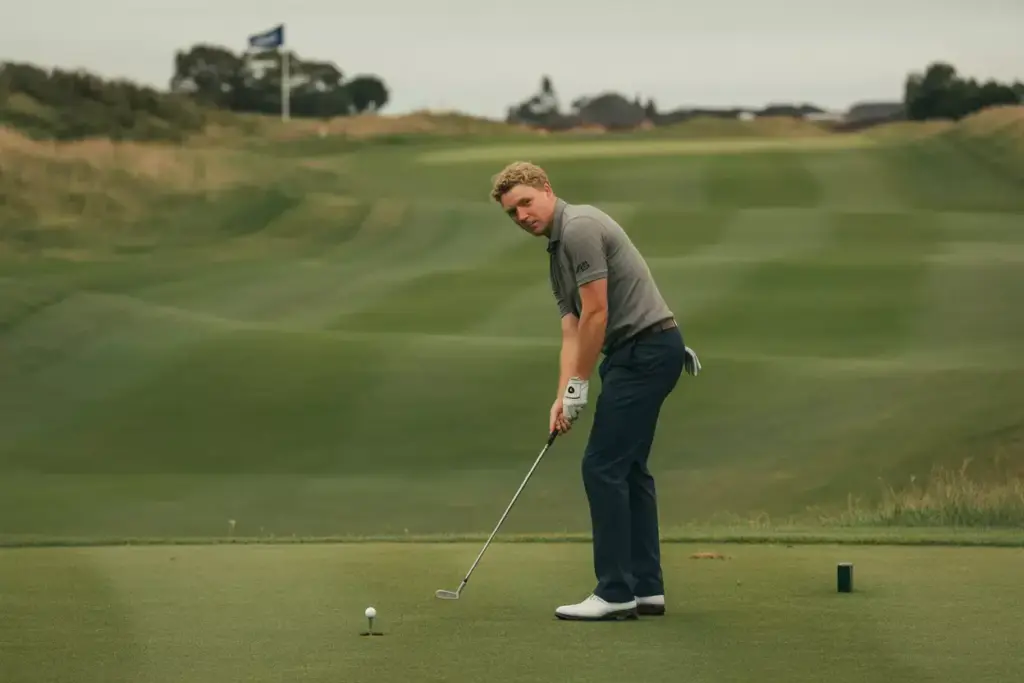 A Golfer Analyzing The Course During A Pre Shot Routine With A Club On A Fairway