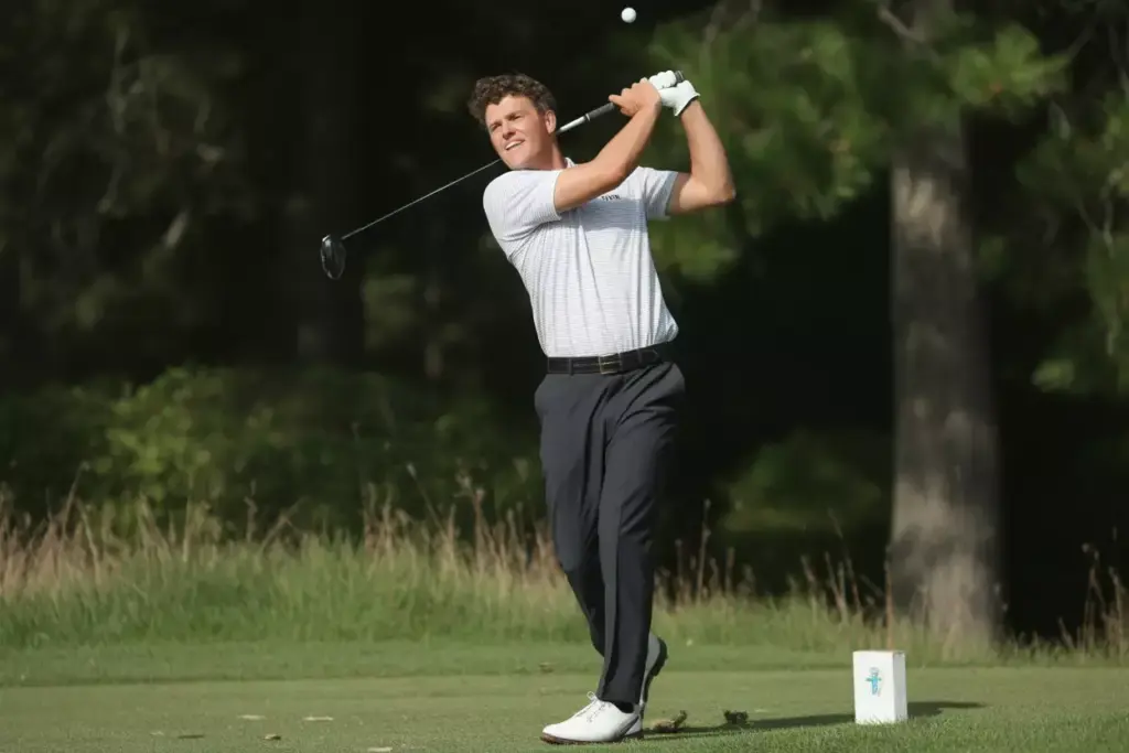 A Golfer In A Natural Balanced Follow Through Watching The Ball Flight