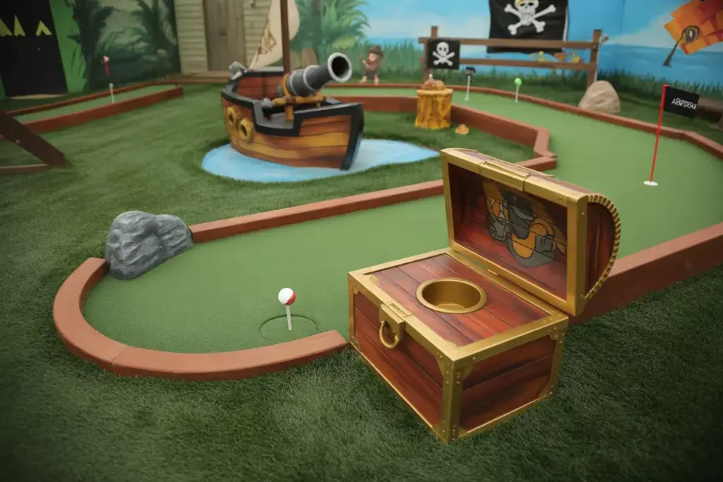 A Pirate Themed Backyard Mini Golf Hole With A Ship Obstacle And Treasure Chest Hole Cup