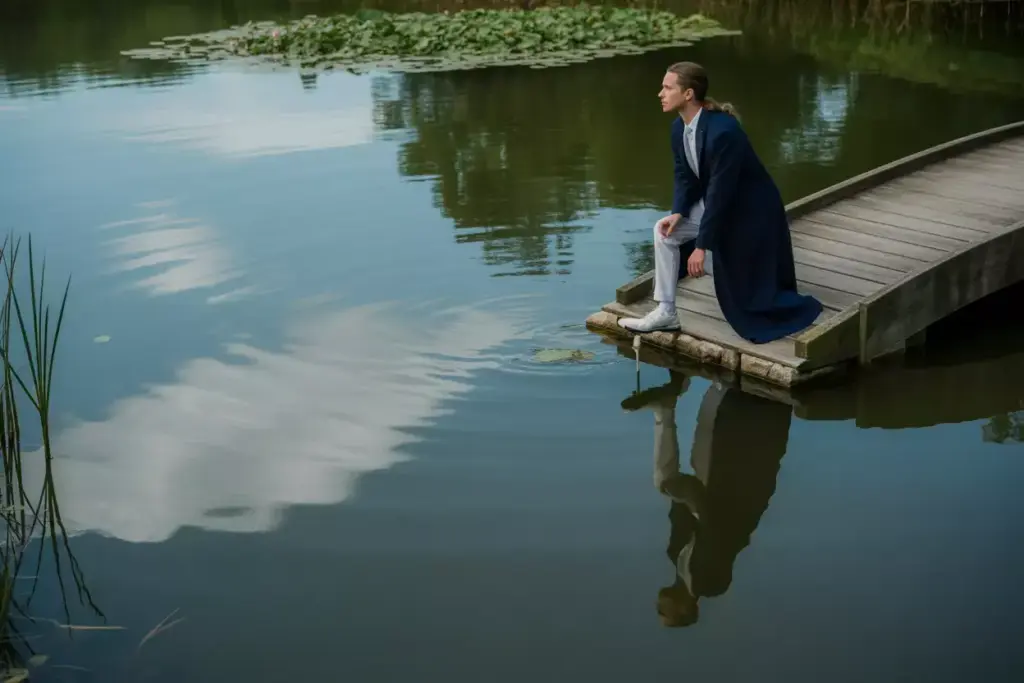 Water Hazard Reflections Senior Portrait Graduate By Pond With Perfect Reflection And Bridge