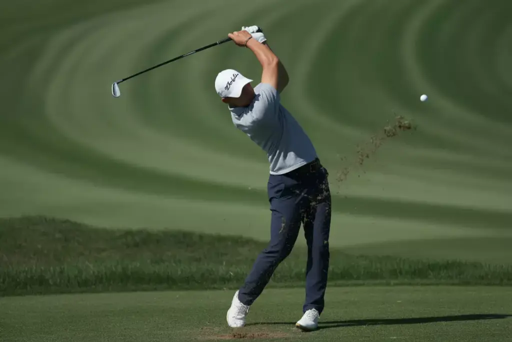 A Golfer At The Peak Of The Backswing Showing Full Rotation Shot From The Target Line