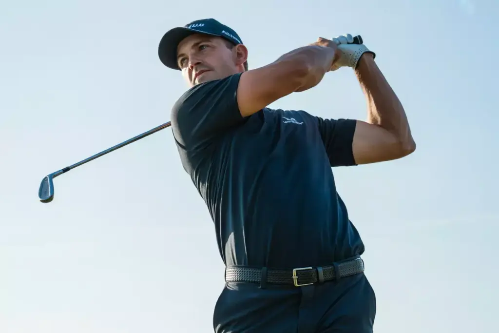 A Golfer In Balanced Follow Through Pose Shot From A Low Heroic Angle