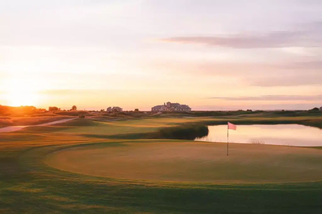 Sunset Golf Course With Pink Sky And Water Reflection Landscape