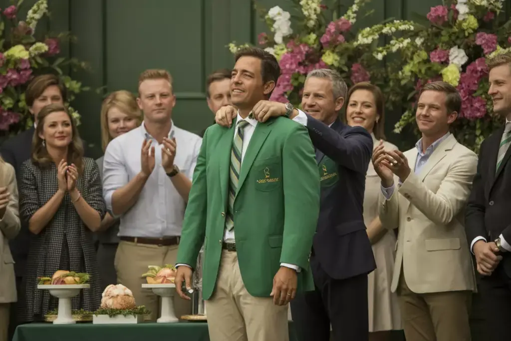A Masters Style Green Jacket Presentation Ceremony With Floral Decor And Traditional Fare